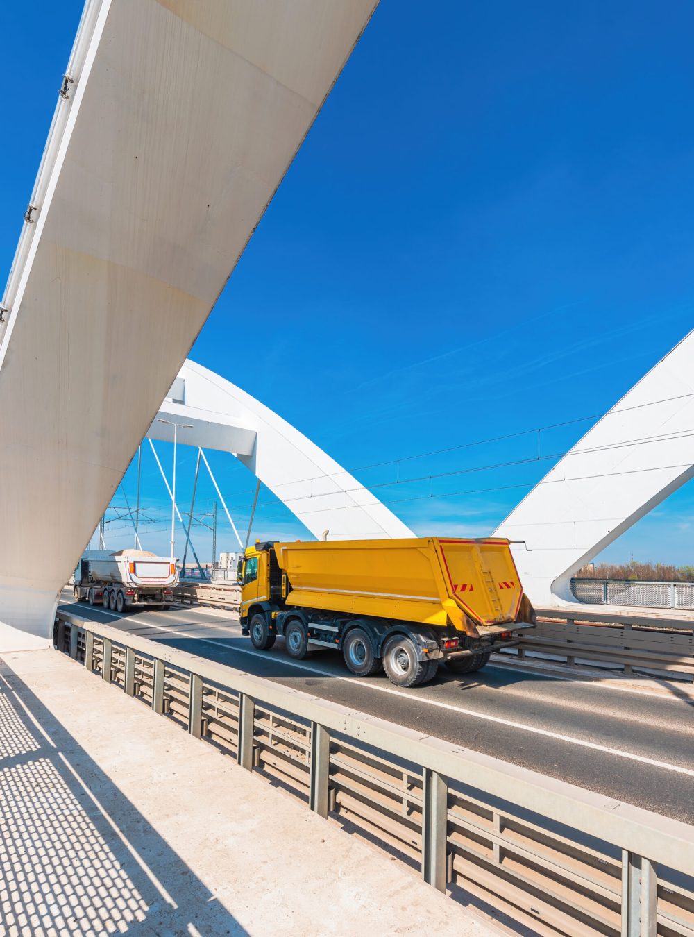 Truck with tipper semi trailer crossing the bridge, selective focus